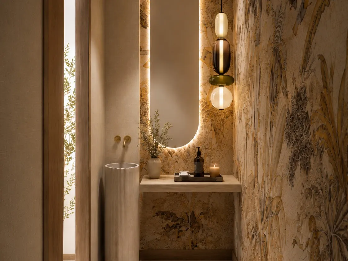 Powder room — banana-leaf mural, backlit oval mirror, fluted stone basin